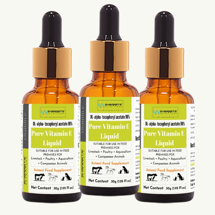 Three bottles of Sharrets Pure Vitamin E Liquid with dropper caps on a white background