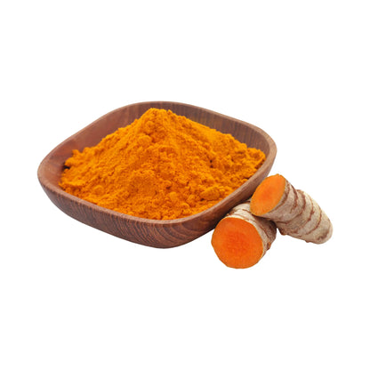 Turmeric powder in a wooden bowl with turmeric roots on a white background